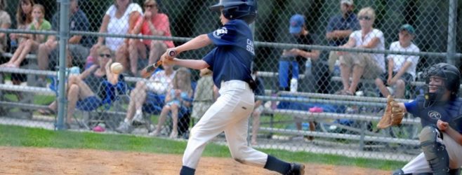 young child playing baseball