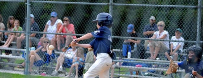 young child playing baseball