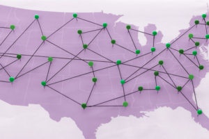 map with pins connecting the United States together