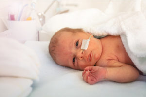A baby in an intensive care unit hospital crib