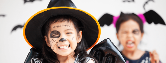 two children in halloween costumes