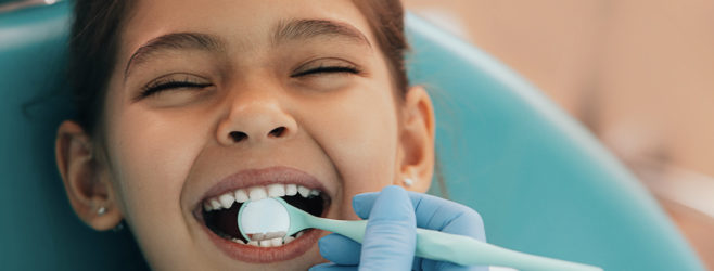 Child at the dentist getting a checkup.