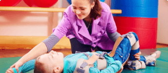 young boy with cerebral palsy receiving physical therapy