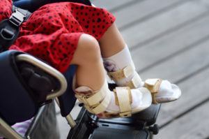 girl with leg braces in a wheelchair