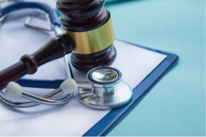 Gavel and stethoscope on a desk.