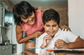 A parent helps a child with homework