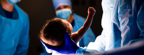 A doctor delivers a baby