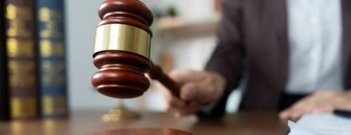 A judge strikes a wooden gavel