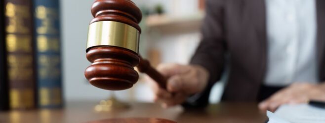 A judge strikes a wooden gavel