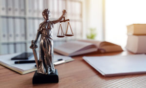 Small Lady of Justice statue on the desk of a Delaware birth injury lawyer