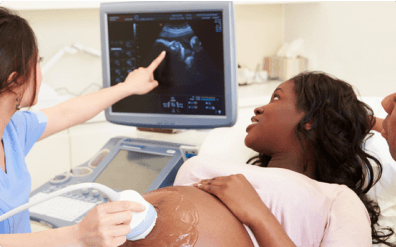 mother and father with doctor looking at sonogram